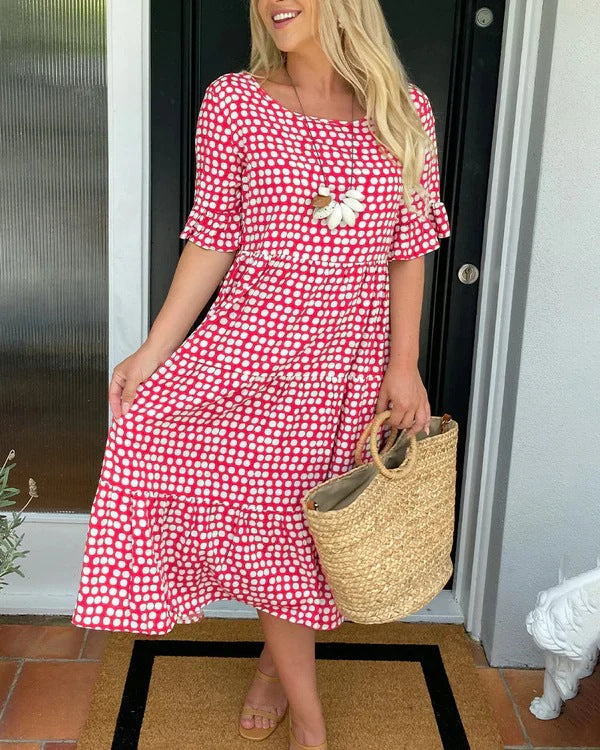Women's black dotted midi dress with relaxed fit, perfect for casual spring & summer fashion.