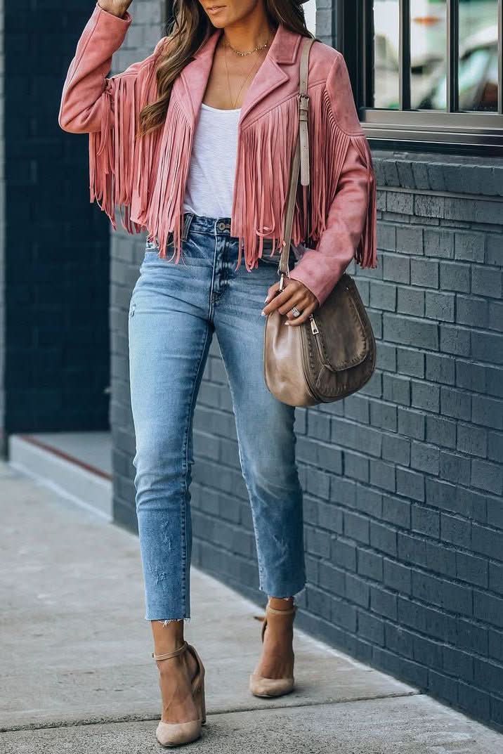 Pink fringed moto jacket for women, a stylish outerwear piece for casual outfits or travel adventures.