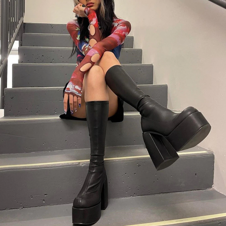 Chic women's black ankle boots featuring a sturdy tall heel, offering comfort & edgy style for any occasion.