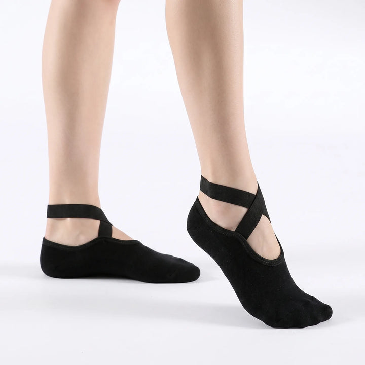 Women's black athletic grip socks, ideal for non-slip yoga, pilates, barre & studio workouts.