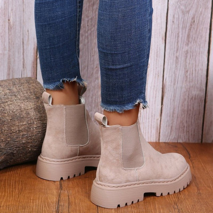 Modern women's platform Chelsea ankle boots. Features elastic sides, a chunky sole, and convenient pull-on design.