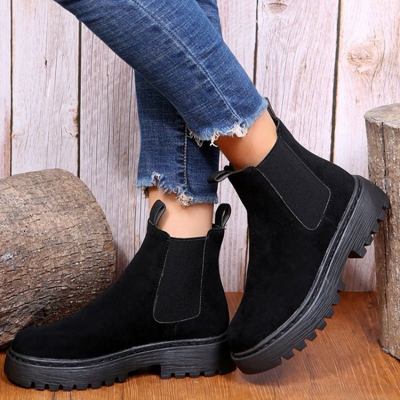 Black women's platform Chelsea boots. Fashionable chunky sole and elastic gussets for an easy pull-on ankle boot style.