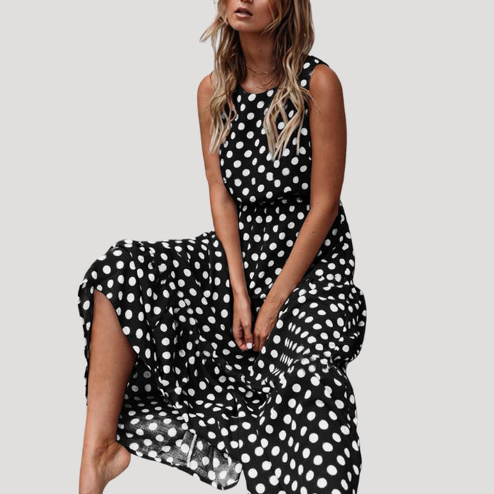 Flowy polka dot sleeveless midi dress for women, ideal as a comfortable round neck summer sundress.