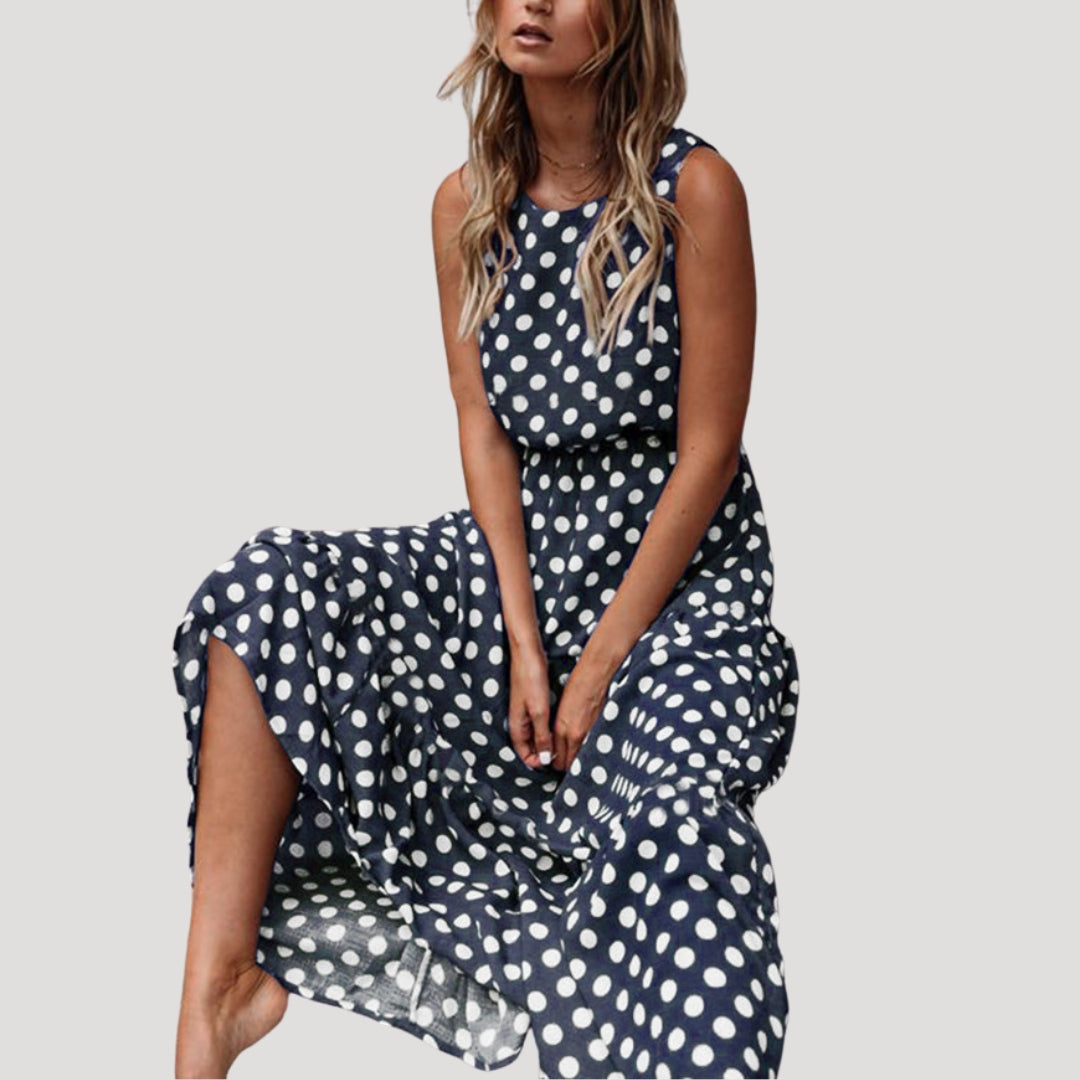 Stylish women's polka dot sleeveless midi dress, a flattering A-line summer sundress with round neck.
