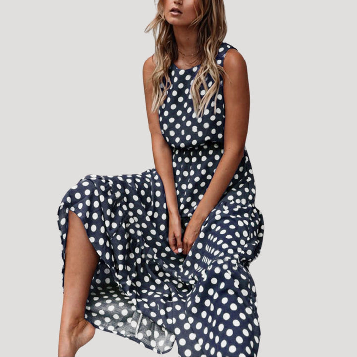 Stylish women's polka dot sleeveless midi dress, a flattering A-line summer sundress with round neck.