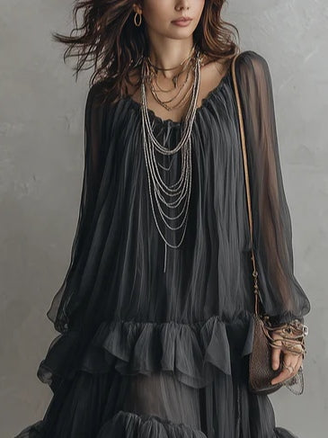 Effortless black tiered maxi dress for women, featuring a V-neck and delicate ruffles. Perfect casual summer evening wear.