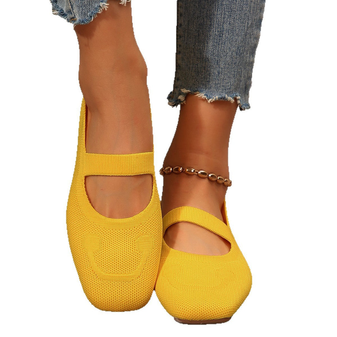 Top down view of cute women's slip-on Mary Jane ballet flats with a distinctive smiling face accent.