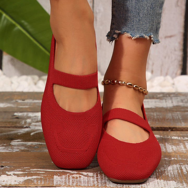 Women's Mary Jane ballet flats in a close-up, showcasing the charming smiling face detail and strap.
