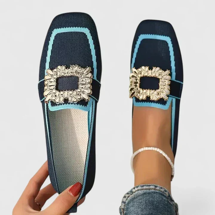 Women's black square toe mules with sparkling rhinestone buckle. Flat, slip-on comfort mules.