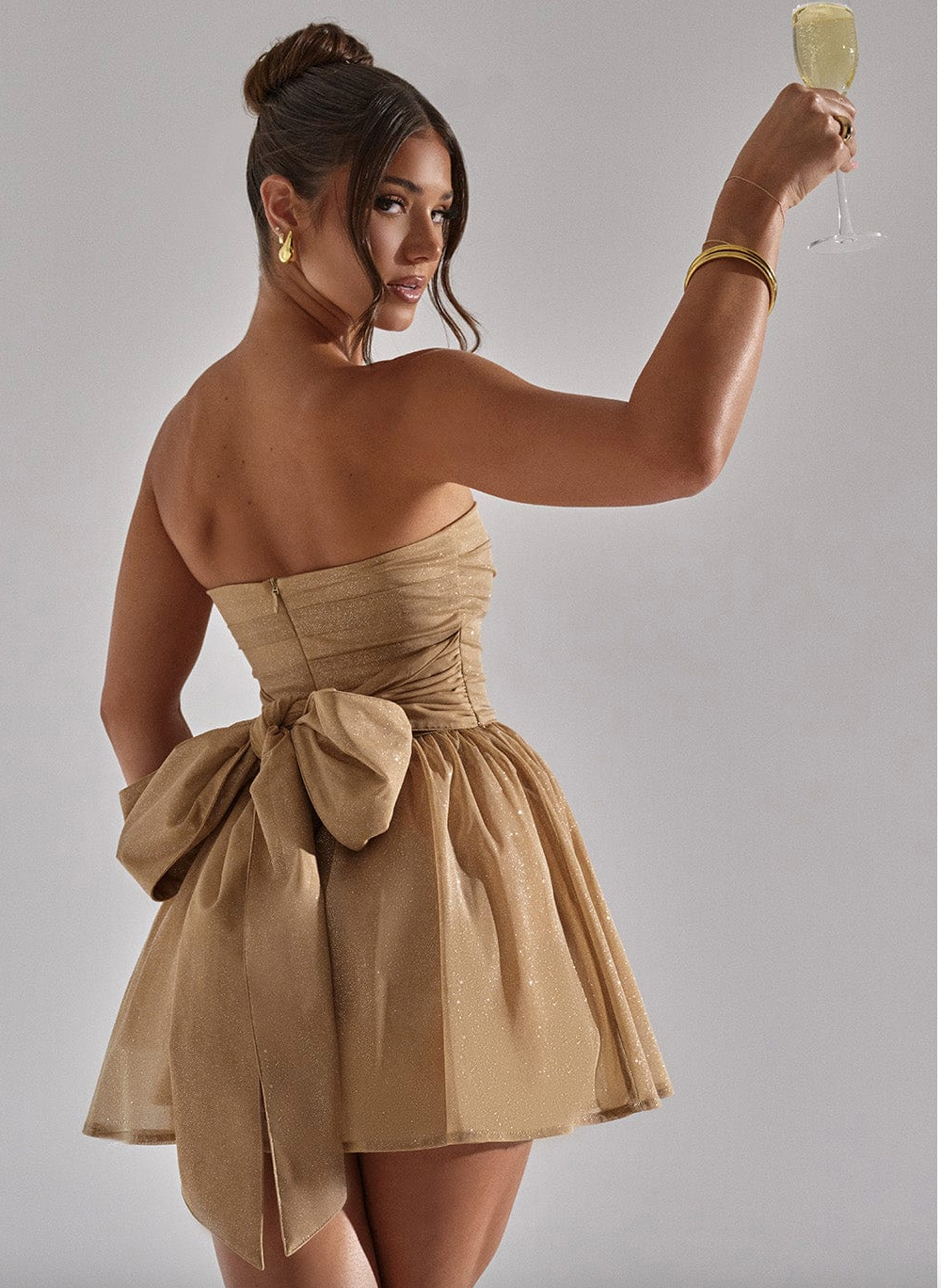 Elegant strapless glitter mini dress for women. A stylish skater silhouette, great for evening events.