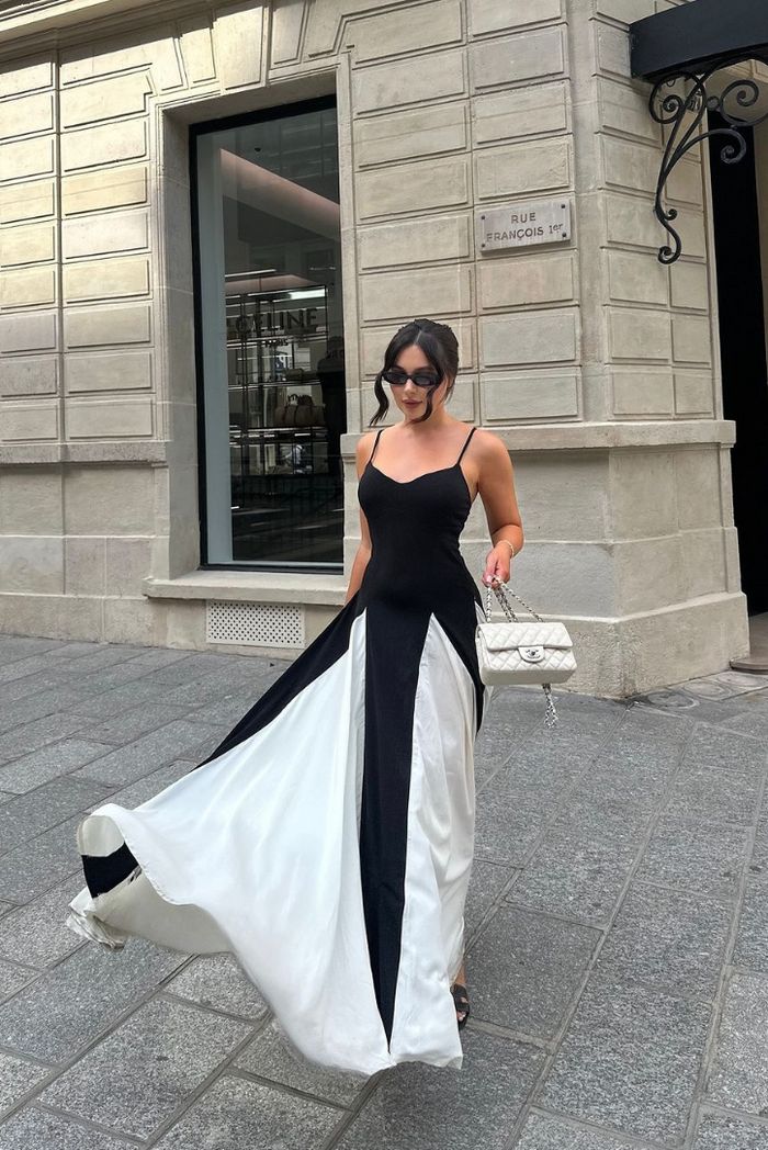 Chic women's black & white maxi wedding guest dress with a striking contrast panel design.