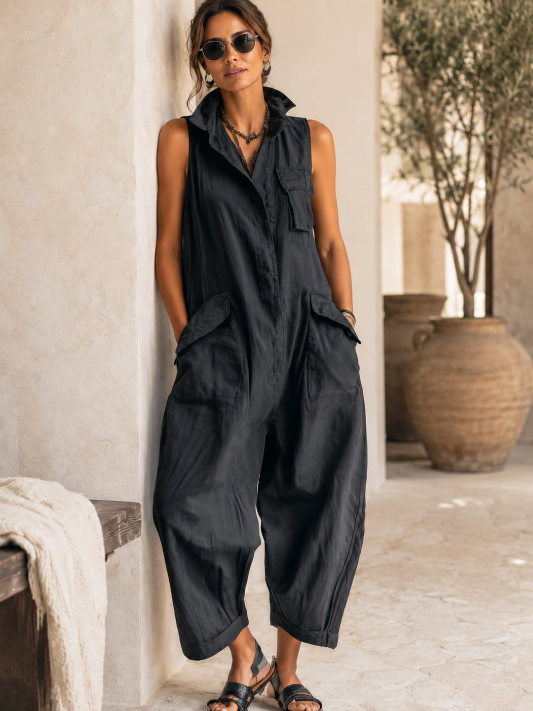Versatile women's black wide-leg jumpsuit, sleeveless and collared, a comfortable and stylish wardrobe essential.