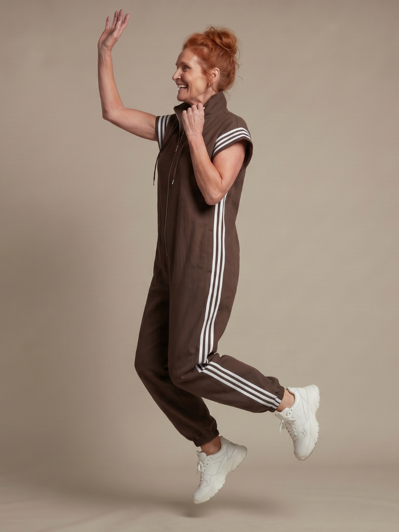 Comfortable women's jumpsuit, perfect for summer. Zip front, high neck, and sporty side stripe accents.