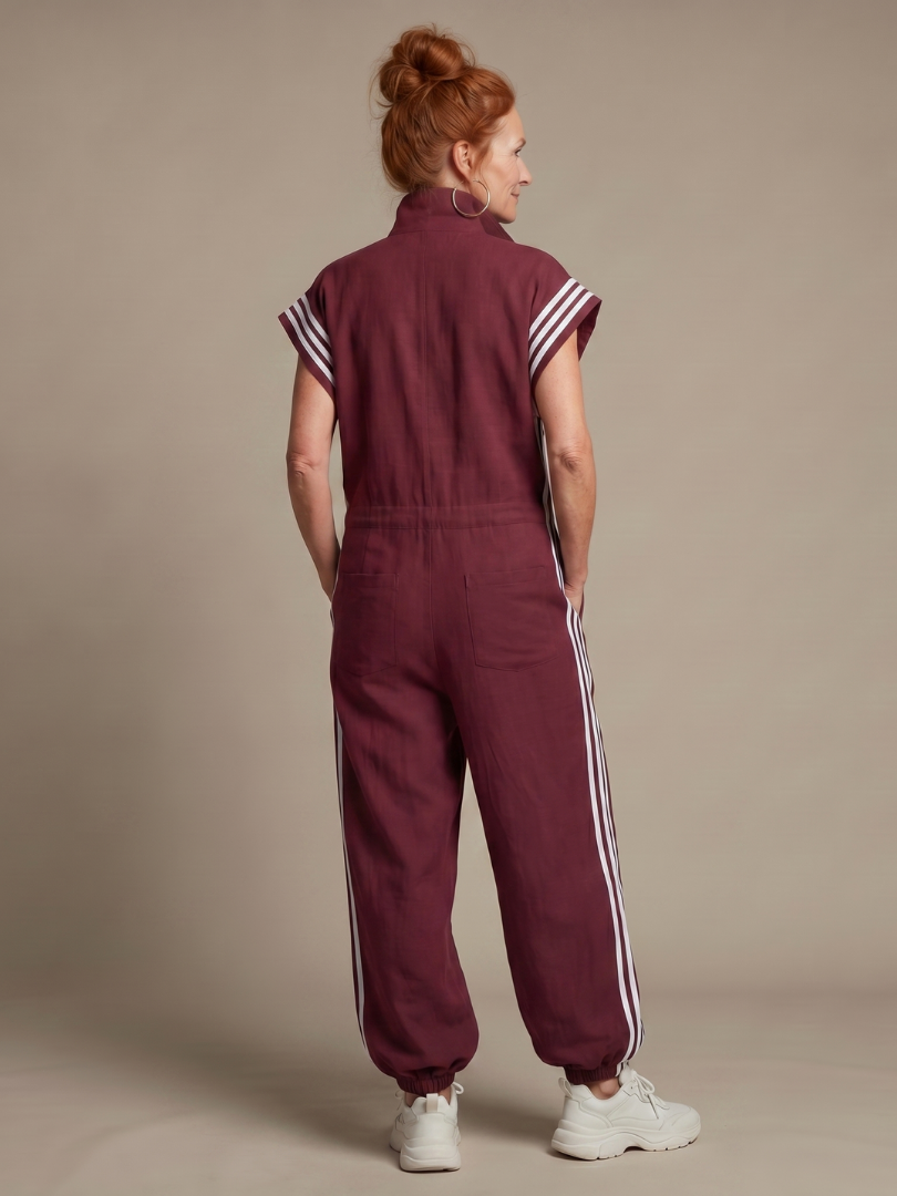 Stylish women's full length jumpsuit with practical zip front, cap sleeves, and trendy sporty side panels.