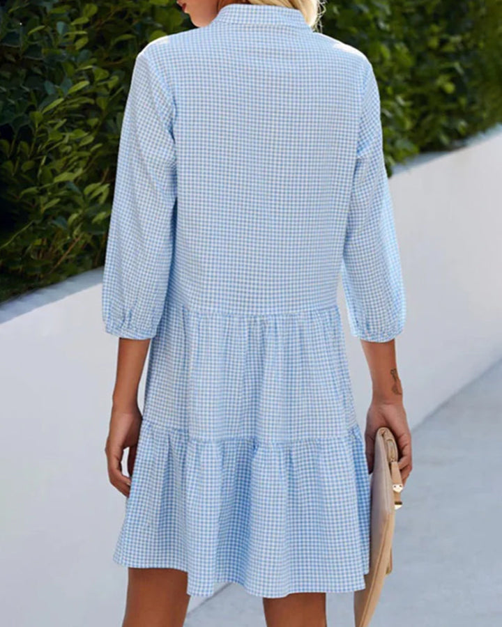 Stylish women's blue check tiered summer dress with short sleeves and a button-down front. Perfect for spring/summer.