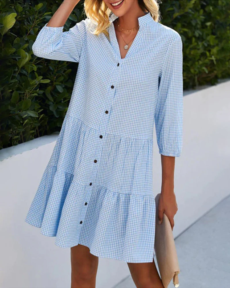 Close-up of a women's blue and white check pattern summer dress, highlighting the fabric and button details.