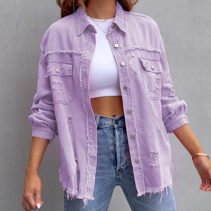 Distressed cuff detail of a women's frayed denim jacket, adding edgy style to casual fashion outerwear.