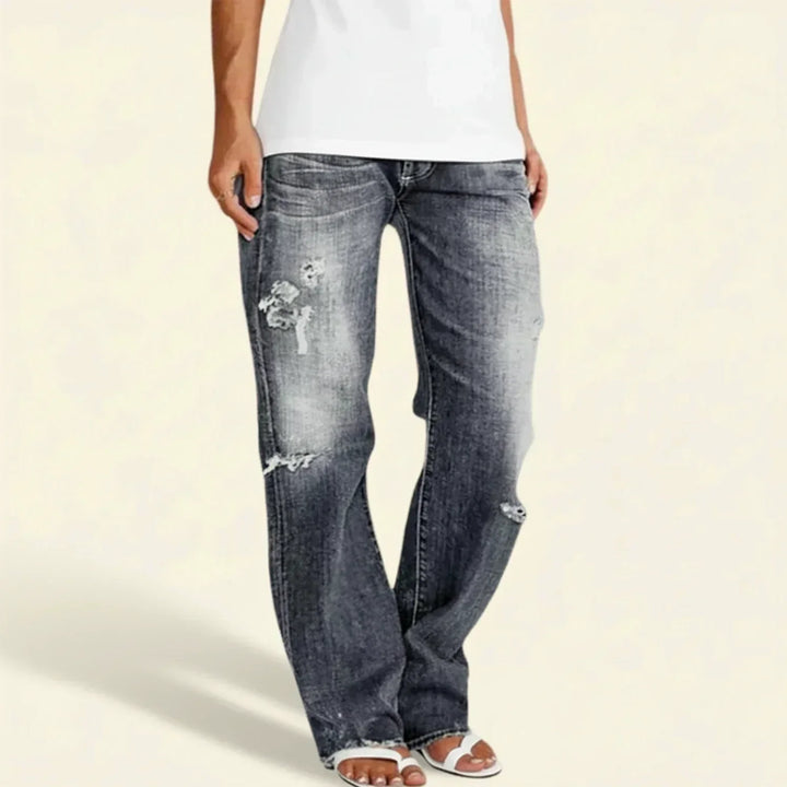 Fashionable women's high waist distressed straight leg jeans, relaxed fit blue denim.