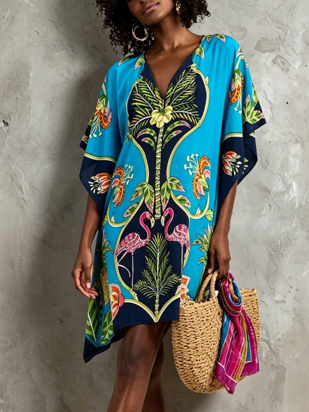Women's blue tropical midi dress with V-neck & batwing sleeves. Perfect for summer resort wear & vacation style.