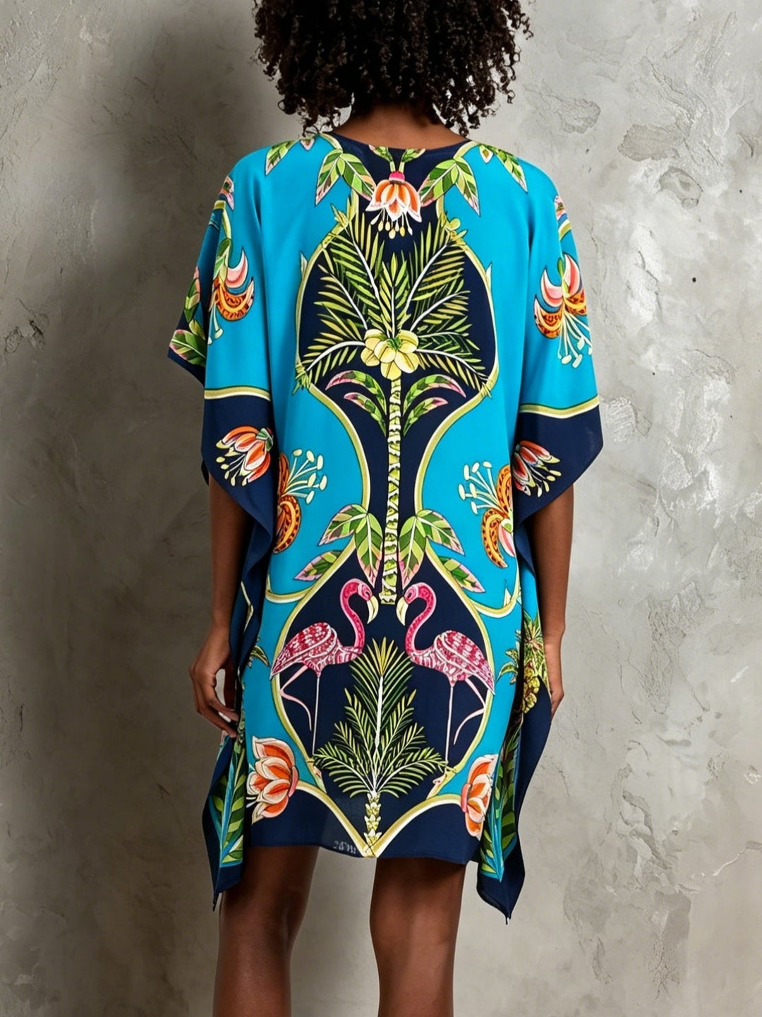 Flowy blue tropical kaftan midi dress for women, featuring a V-neck and batwing sleeves. Ideal beachwear.