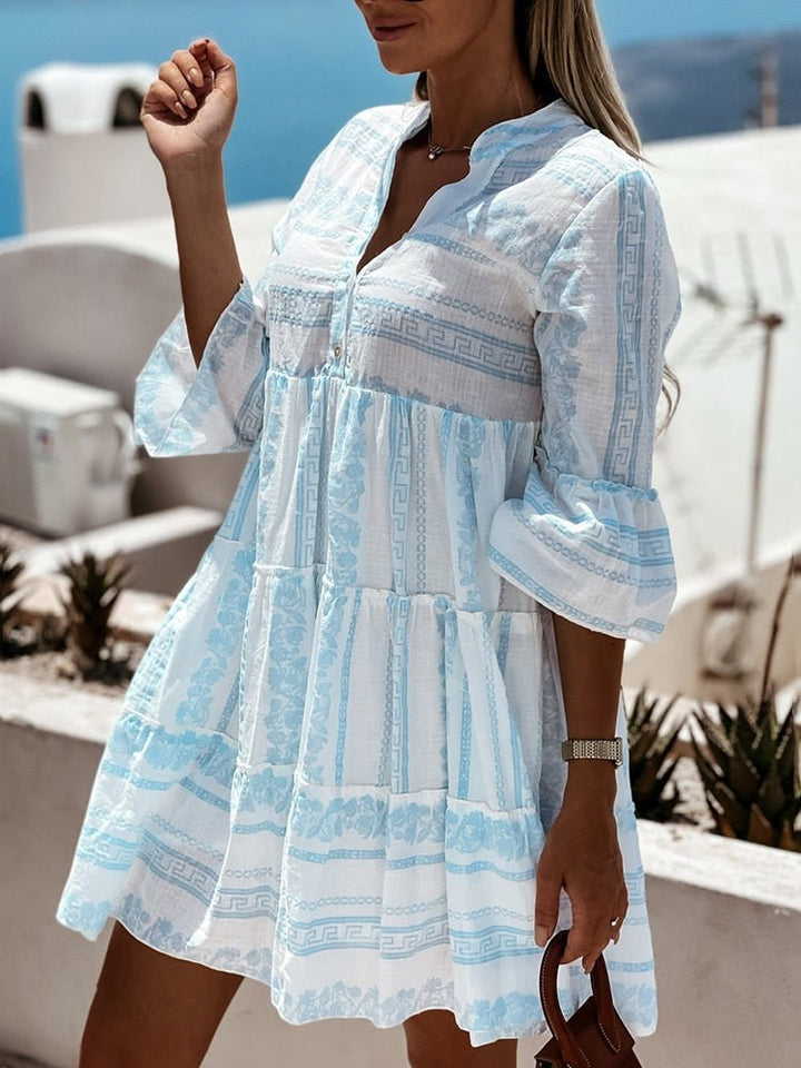 Versatile women's tiered mini dress, boho print, flare sleeves, perfect for beachwear & summer fashion.