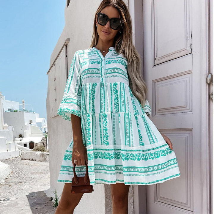 Women's tiered mini dress showcasing a unique boho print, styled with fashionable flare sleeves.