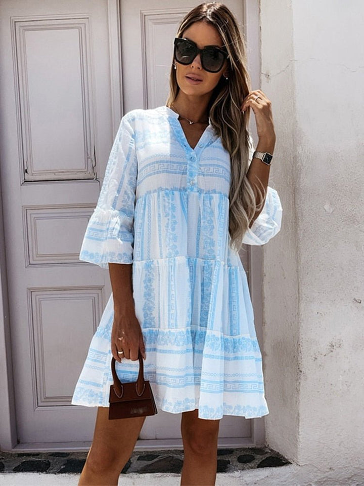 Trendy women's bohemian tiered mini dress, with an eye-catching boho print and stylish flare sleeves.