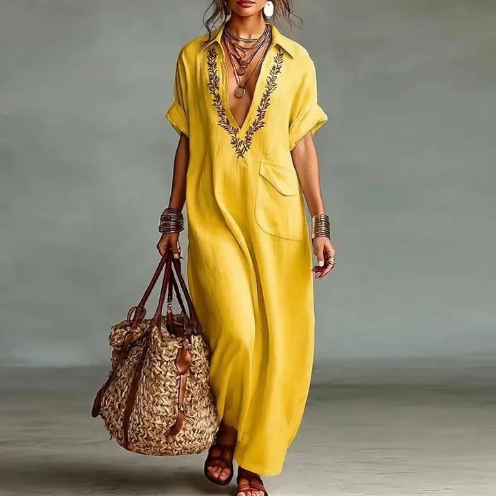 Flowy short sleeve women's maxi dress with V-neck & vibrant bohemian print, perfect for summer fashion.
