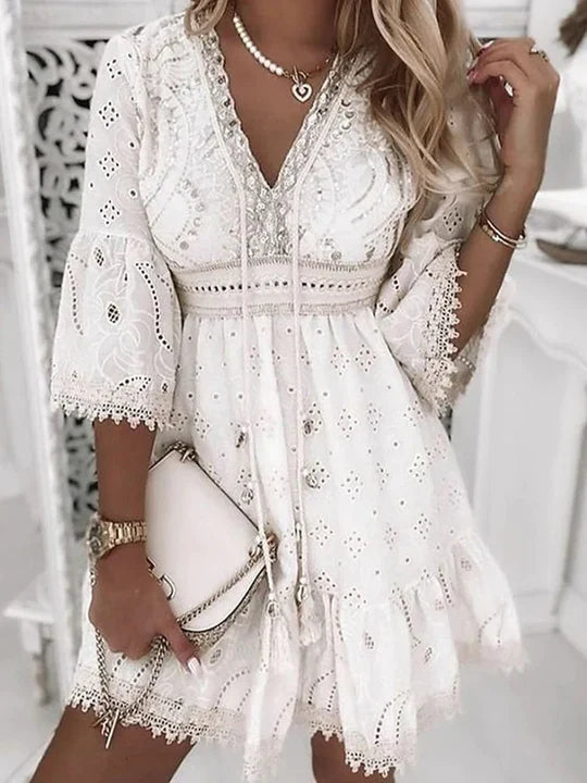 Feminine V-neck embroidered mini dress for women, featuring relaxed fit and stylish flare sleeves.