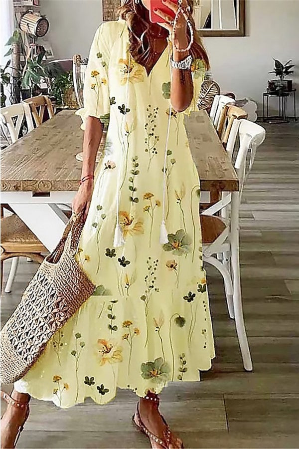 Flowy bohemian floral maxi dress for women, featuring a V-neck and tassel details, perfect for beach or casual summer fashion.
