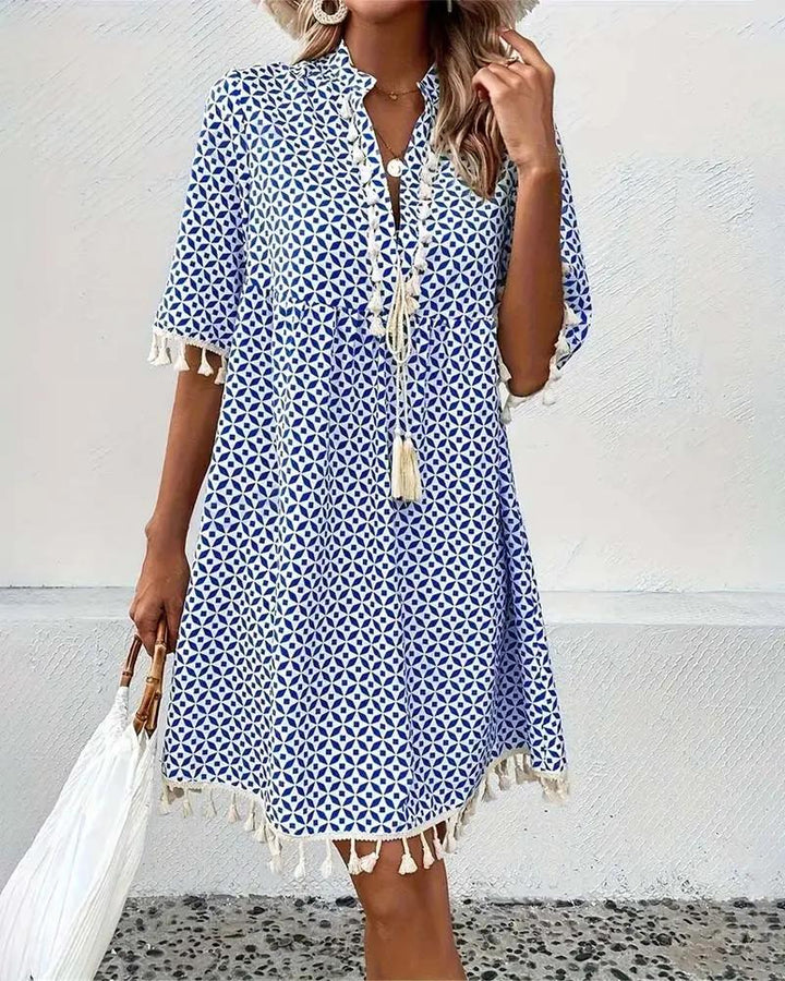 Relaxed fit women's summer mini dress, featuring a chic tassel trim. Ideal for beachwear & vacations.