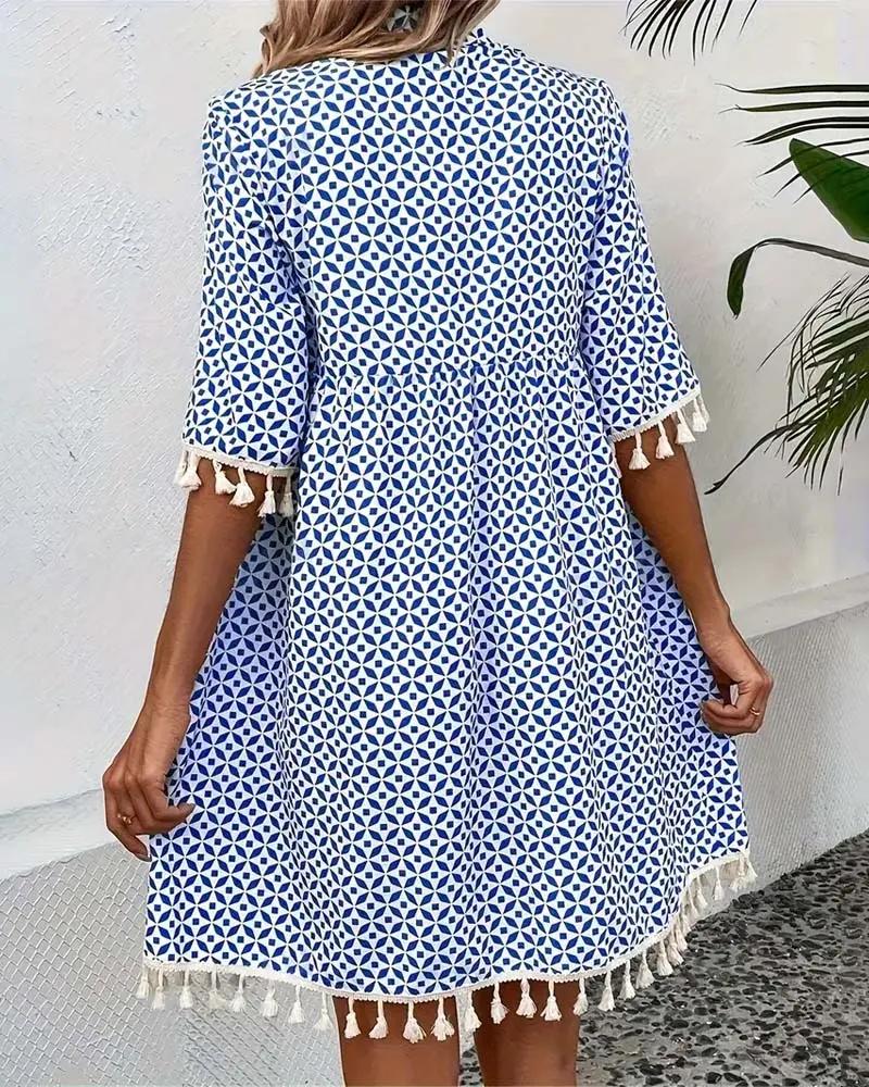 Printed women's casual mini dress with stylish tassel trim & short sleeves. A must-have boho day dress.