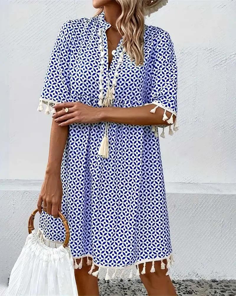 Stylish women's short sleeve mini dress, featuring a playful tassel trim. Perfect casual summer outfit.