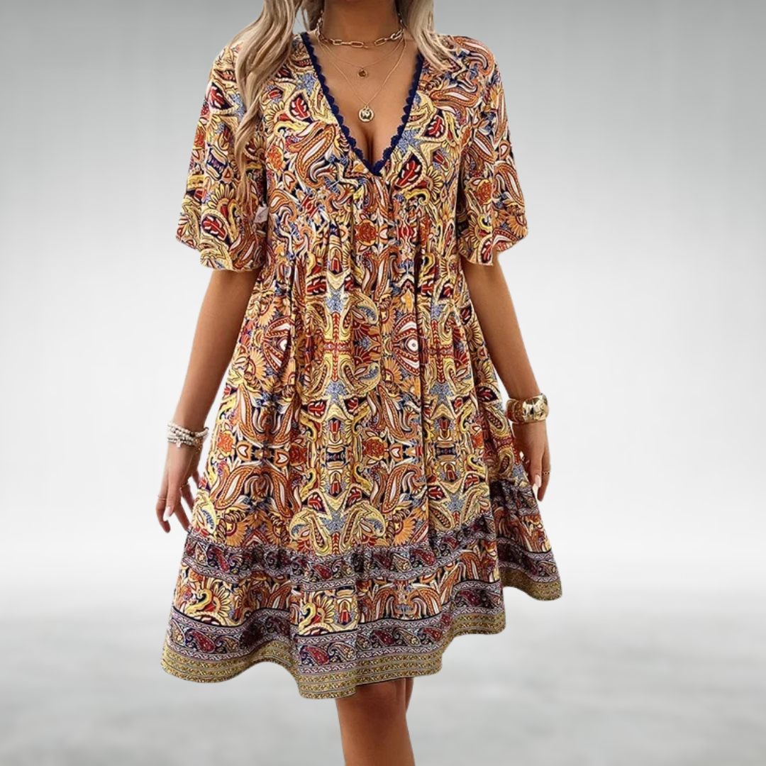 Women's boho mini dress with vibrant paisley print, short sleeves. Ideal for summer casual wear and vacation style.