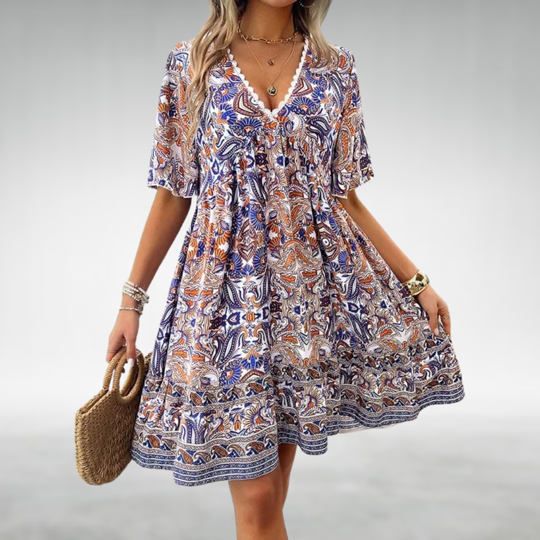 Stylish women's boho mini dress featuring a colorful paisley print and comfortable short sleeves for summer fashion.