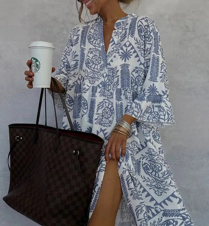 Bohemian chic A-line midi dress featuring vibrant print, V-neck, & comfortable 3/4 sleeves for women.