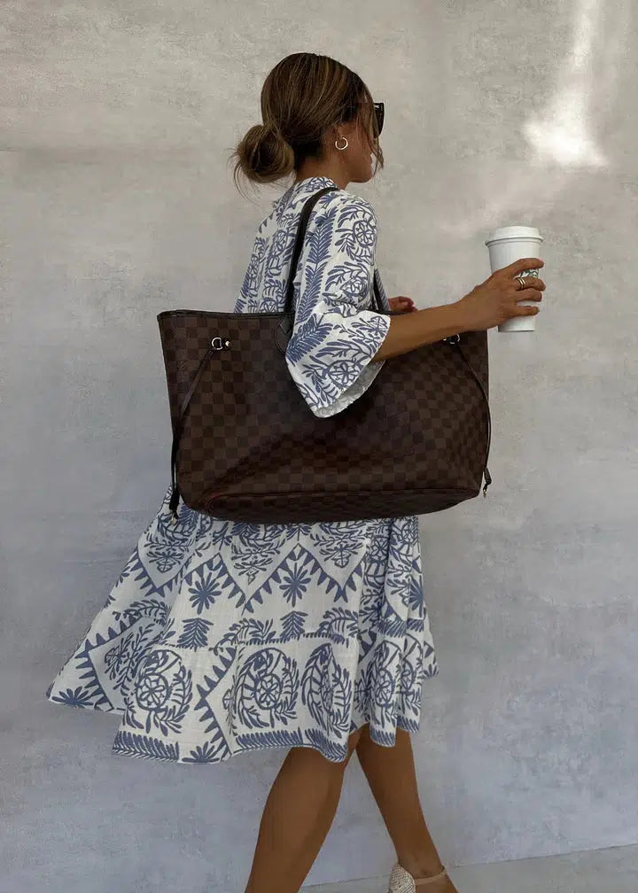 Flowing women's boho print dress; V-neck, 3/4 sleeves, comfortable midi length. Great for summer fashion.