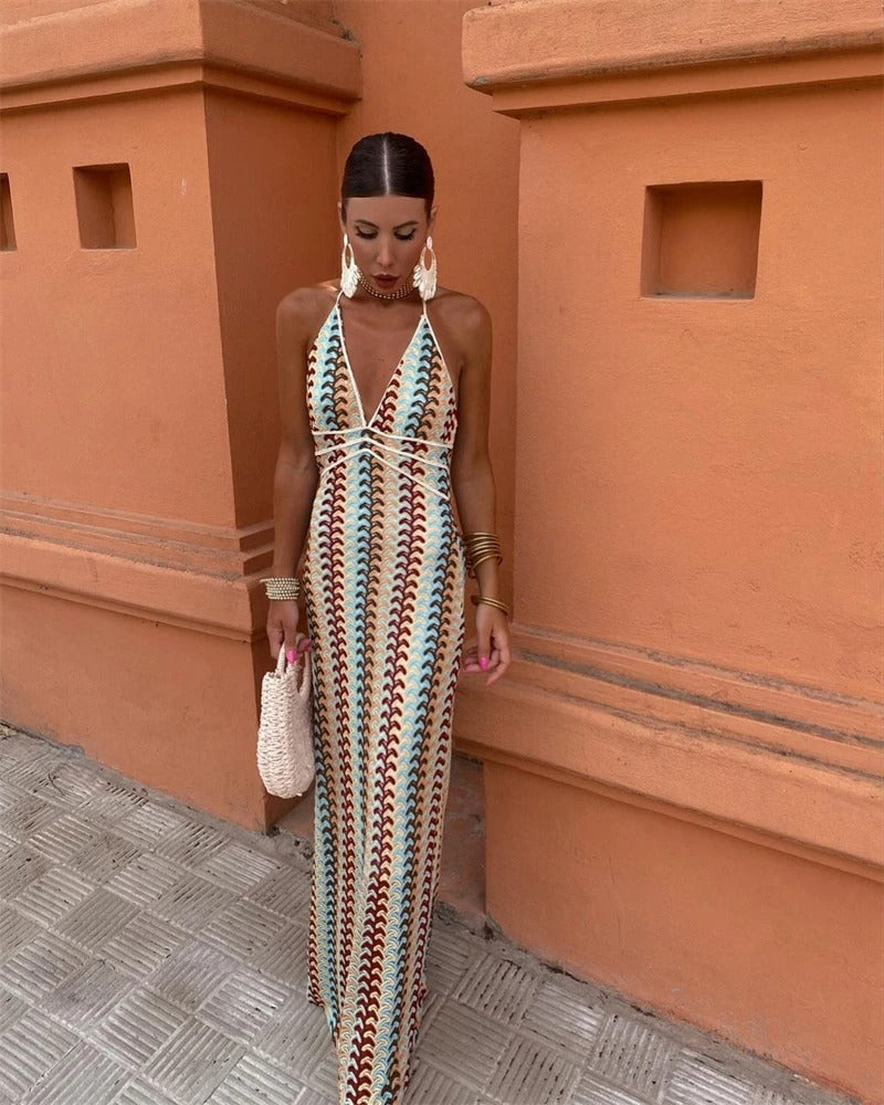 Elegant boho maxi dress with a vibrant print, V-neck, and halter design, ideal for a stylish wedding guest.