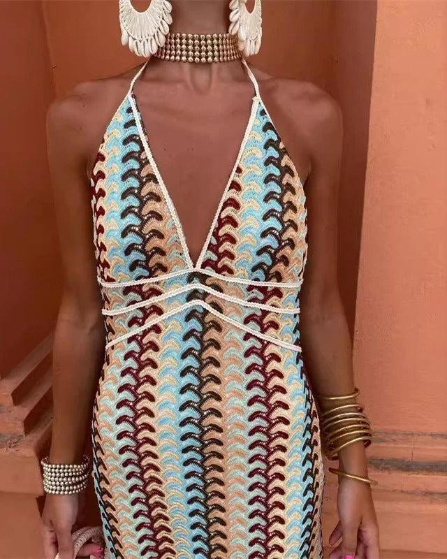 Flowy boho printed maxi dress, featuring an open back and V-neck halter, great for summer parties & vacations.