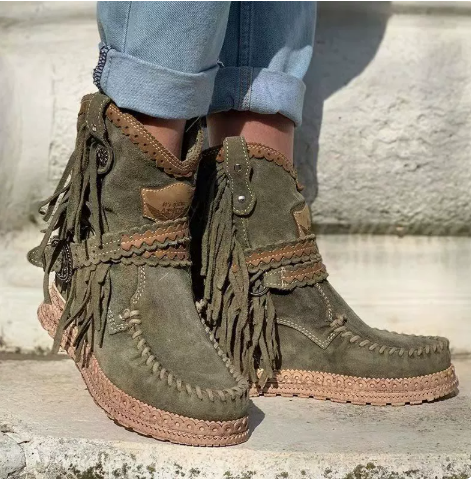 Comfortable women's western ankle boots with playful fringe. Boho style, flat heel, and easy slip-on design.