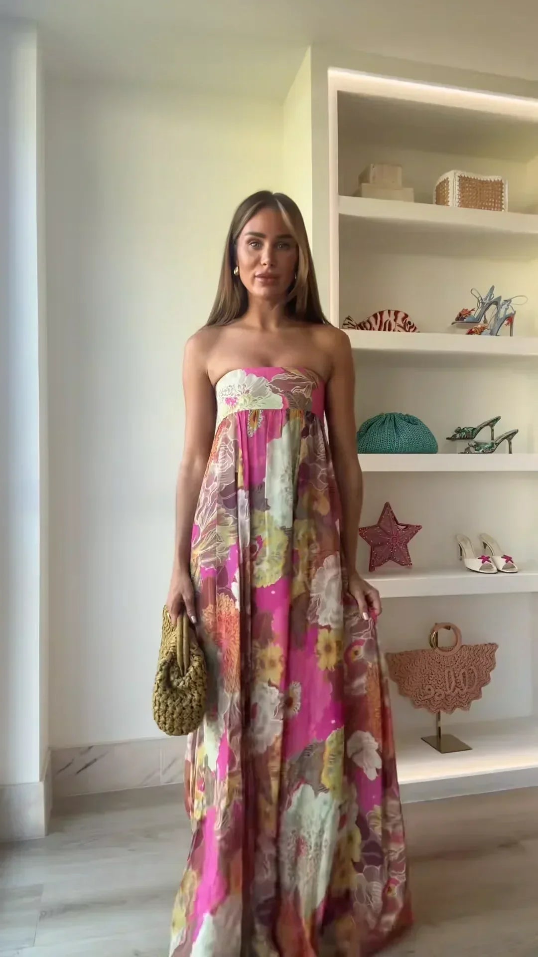Chic women's strapless maxi dress, featuring a bold floral design, suitable for elegant events.