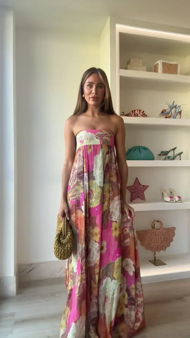 Chic women's strapless maxi dress, featuring a bold floral design, suitable for elegant events.
