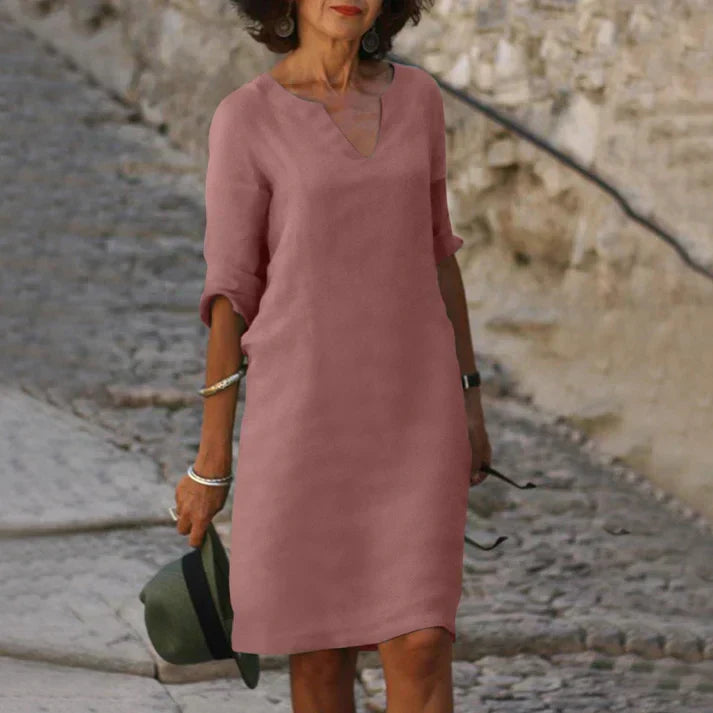 Women's breezy V-neck midi dress, perfect for casual comfort or elegant daywear. Flowy, short-sleeve summer style.