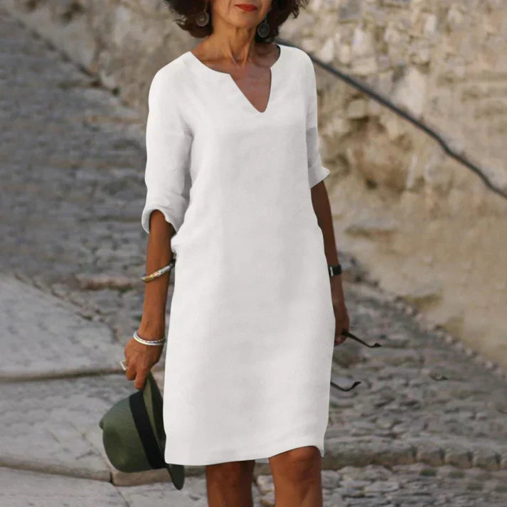Women's V-neck midi dress featuring short sleeves & a breezy, flowy design. Comfortable & stylish for any day.