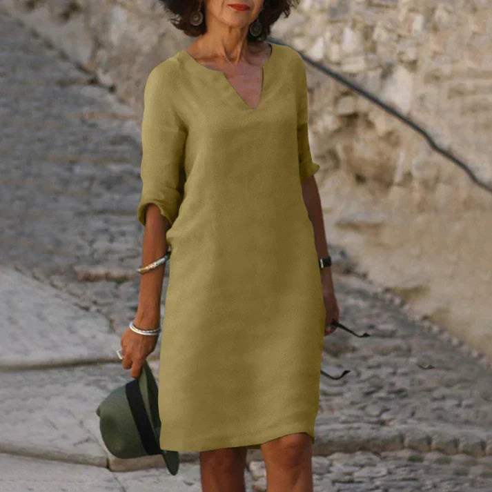 Flowy V-neck midi dress for women, featuring breezy fabric & short sleeves. A comfortable, elegant summer staple.