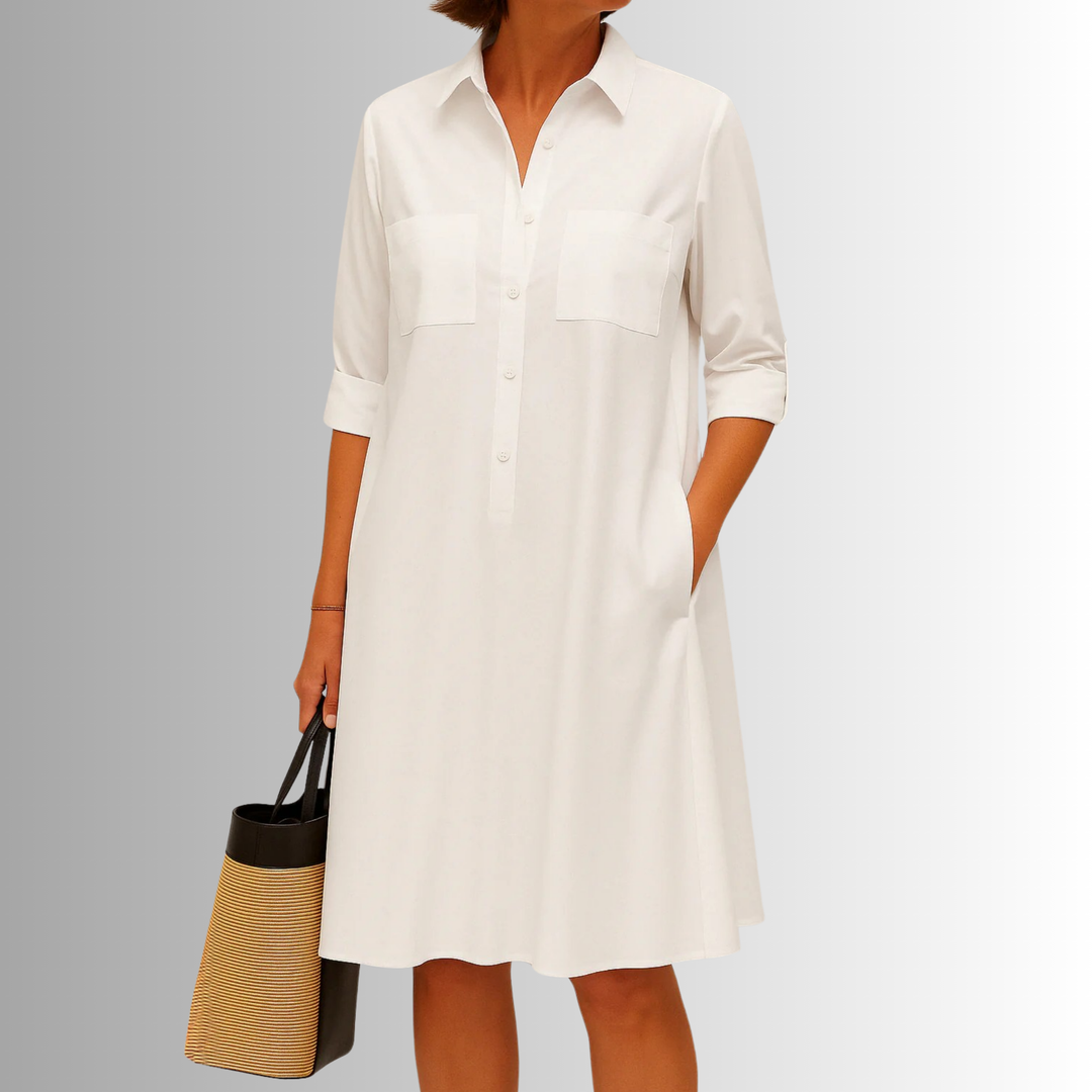 Elegant women's A-line dress featuring a button-down front, collared neckline, short sleeves, and practical pockets.