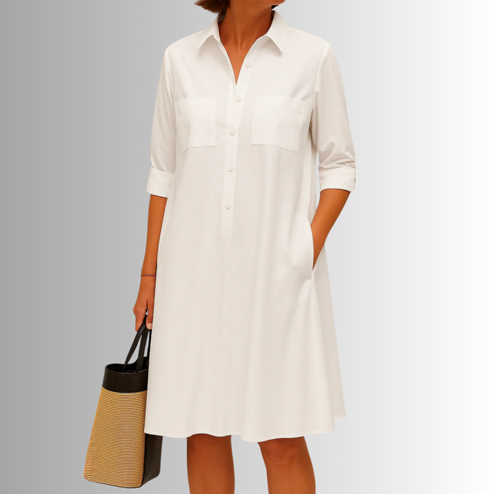 Elegant women's A-line dress featuring a button-down front, collared neckline, short sleeves, and practical pockets.