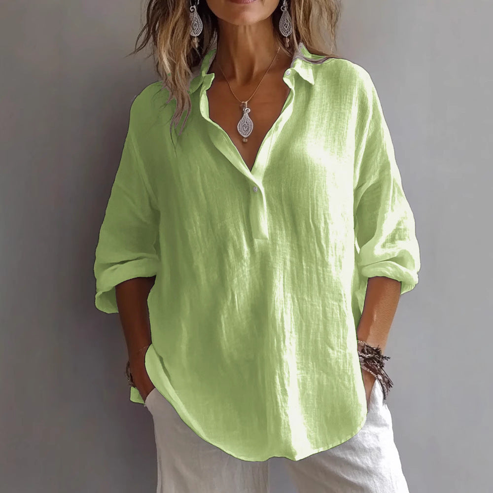 Relaxed fit women's button-down blouse, showcasing wide sleeves for a breezy, chic look.