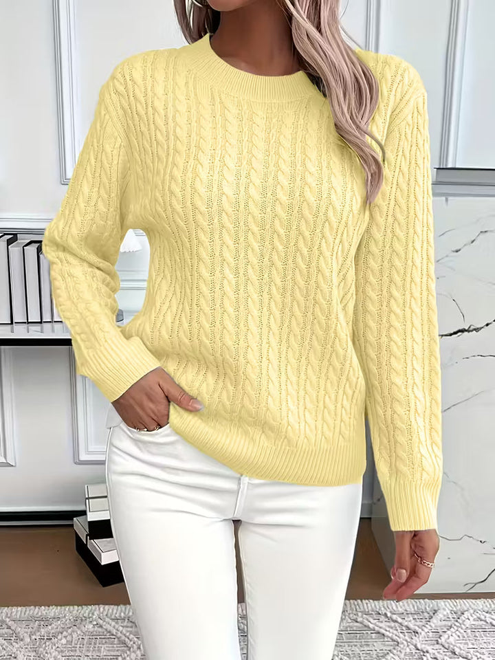 Richly textured women's cable knit crew neck sweater, perfect for adding depth to autumn outfits.