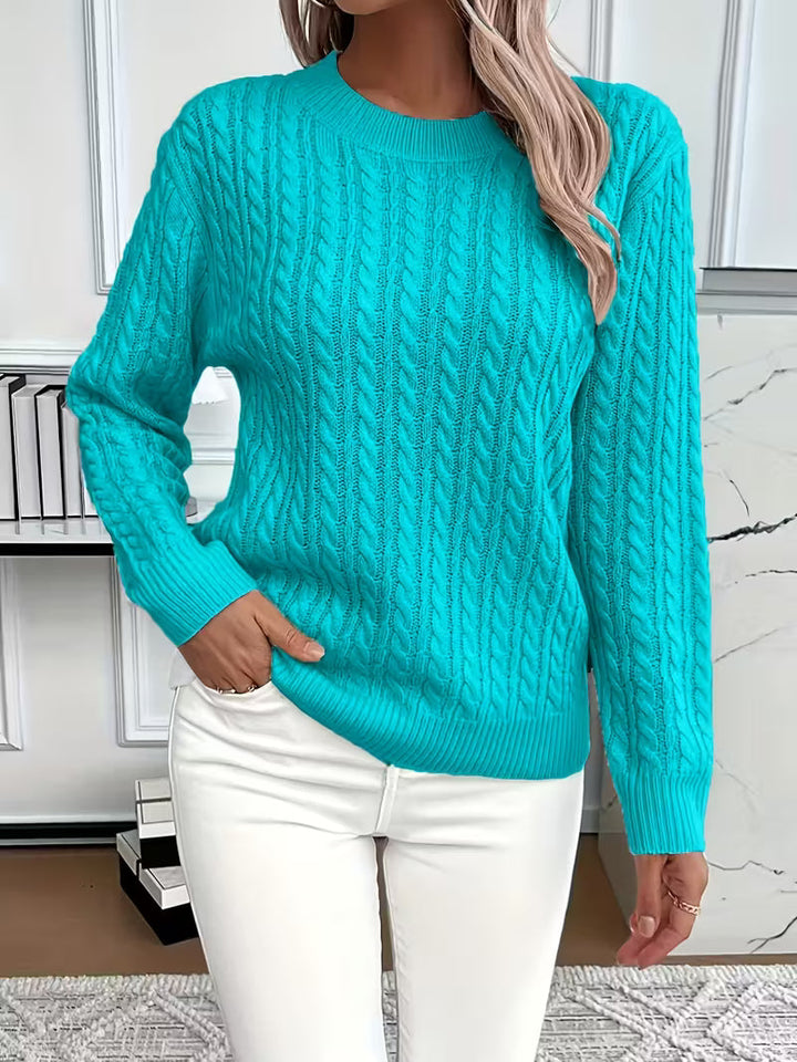 Soft knitwear: women's long-sleeve cable knit crew neck sweater, essential for cool autumn days.